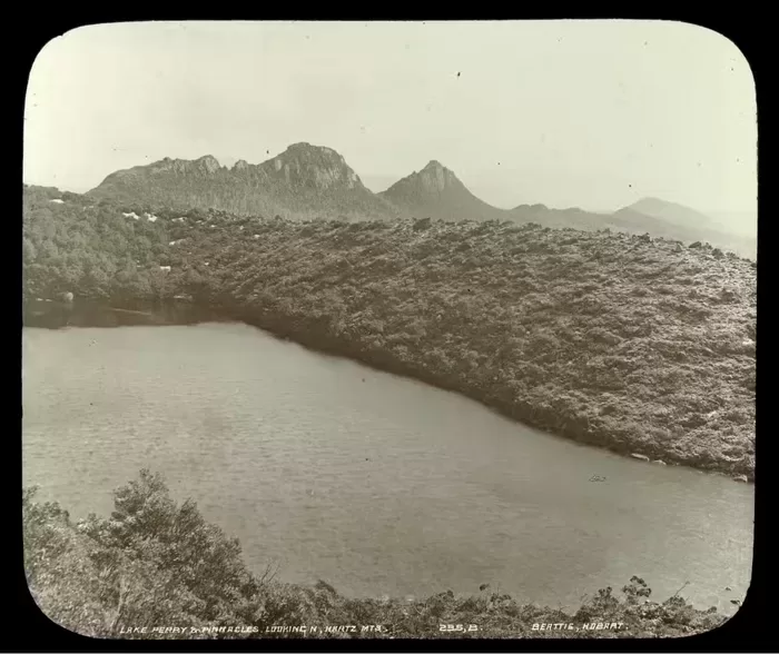 This photograph of Lake Perry in the Hartz Mountains gives a good sense of the gradations of the Tasmanian highlands and the dramatic topography that attracted photographers. John Beattie, Lake Perry and Pinnacles looking Nth, Hartz Mountains, c. 1900. Glass Lantern Slide. Tasmanian Views Collection. State Library of Victoria