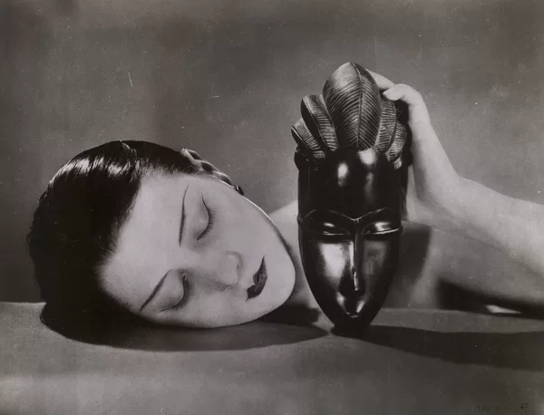 Man Ray, Kiki with African mask, 1926 gelatin silver photograph 21.1 x 27.6 cm (image); 22.1 x 28.5 cm (sheet) National Gallery of Victoria, Melbourne Purchased through The Art Foundation of Victoria with the assistance of Miss Flora MacDonald Anderson and Mrs Ethel Elizabeth Ogilvy Lumsden, Founder Benefactors, 1983 © MAN RAY TRUST / ADAGP, Paris. Licensed by Copyright Agency, Australia Photo: Helen Oliver-Skuse / NGV