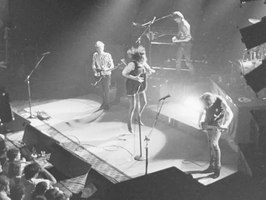 Chrissy Amphlett airborne during a concert at Selina's Coogee © Mark Anning photography 1983