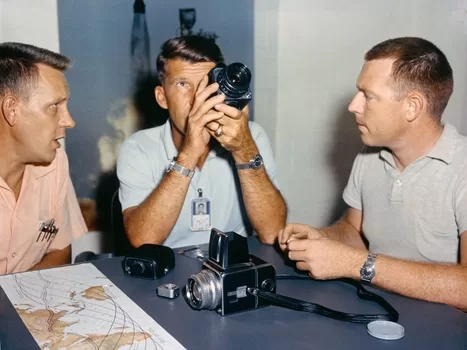 Astronaut Walter "Wally" Schirra, center, with his Hasselblad