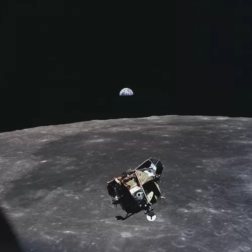 Apollo 11 ascent stage, with astronauts Armstrong and Aldrin aboard, is photographed in lunar orbit